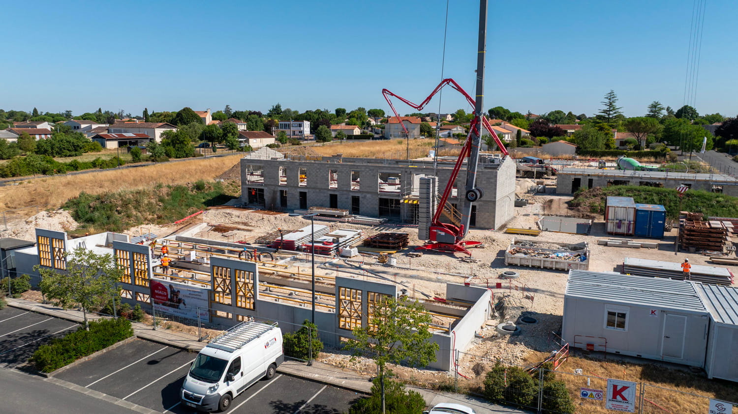 Concrete building under construction with crane