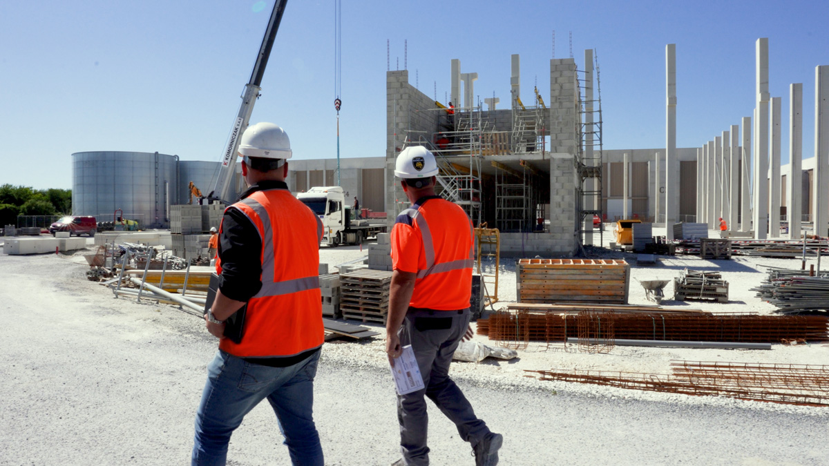 Construction workers inspecting active building site
