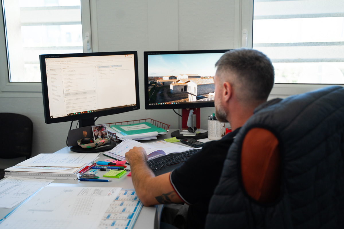 Man working at dual monitors in office